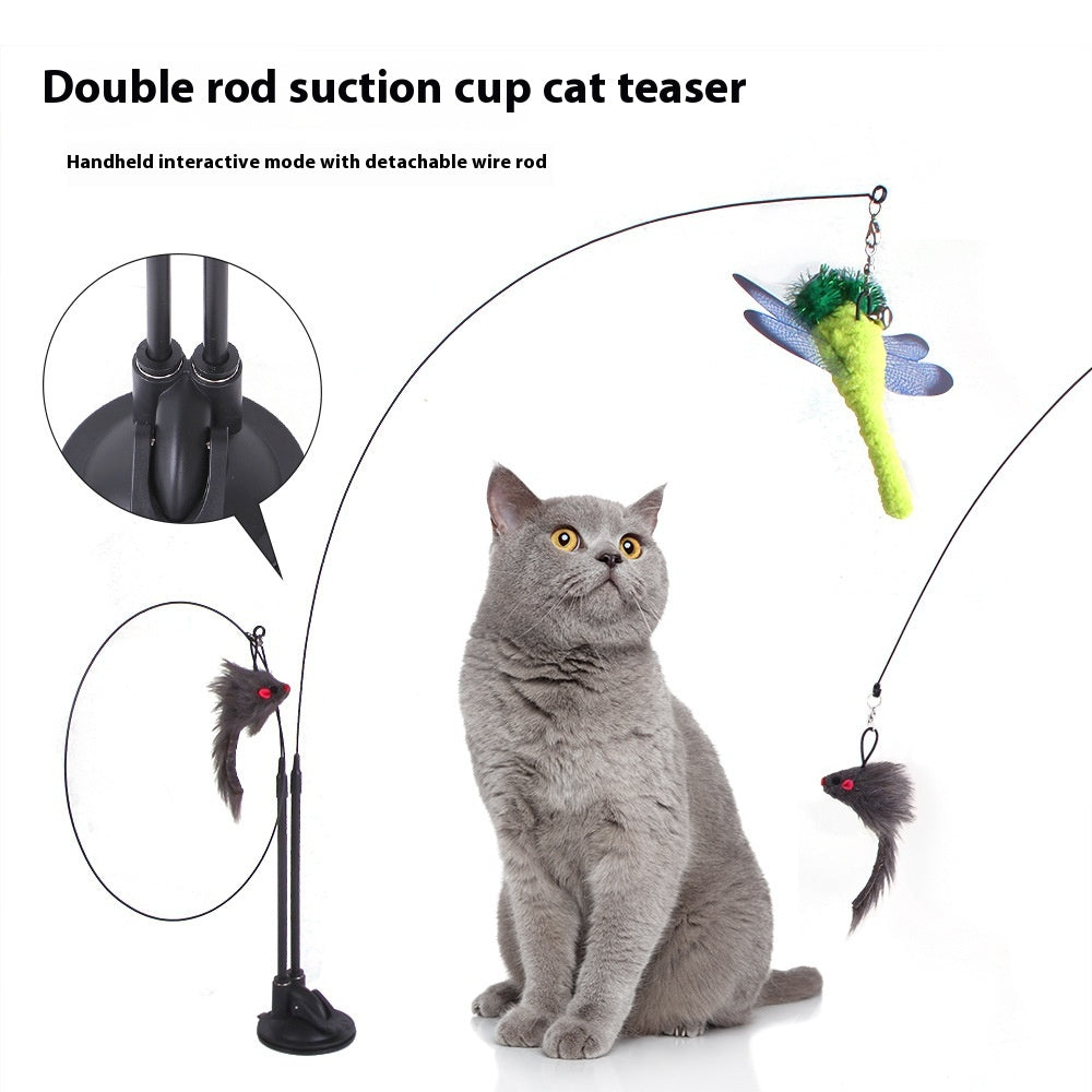 Grey cat looking at a double rod suction cup cat teaser with a green dragonfly and grey mouse plush attachments.
