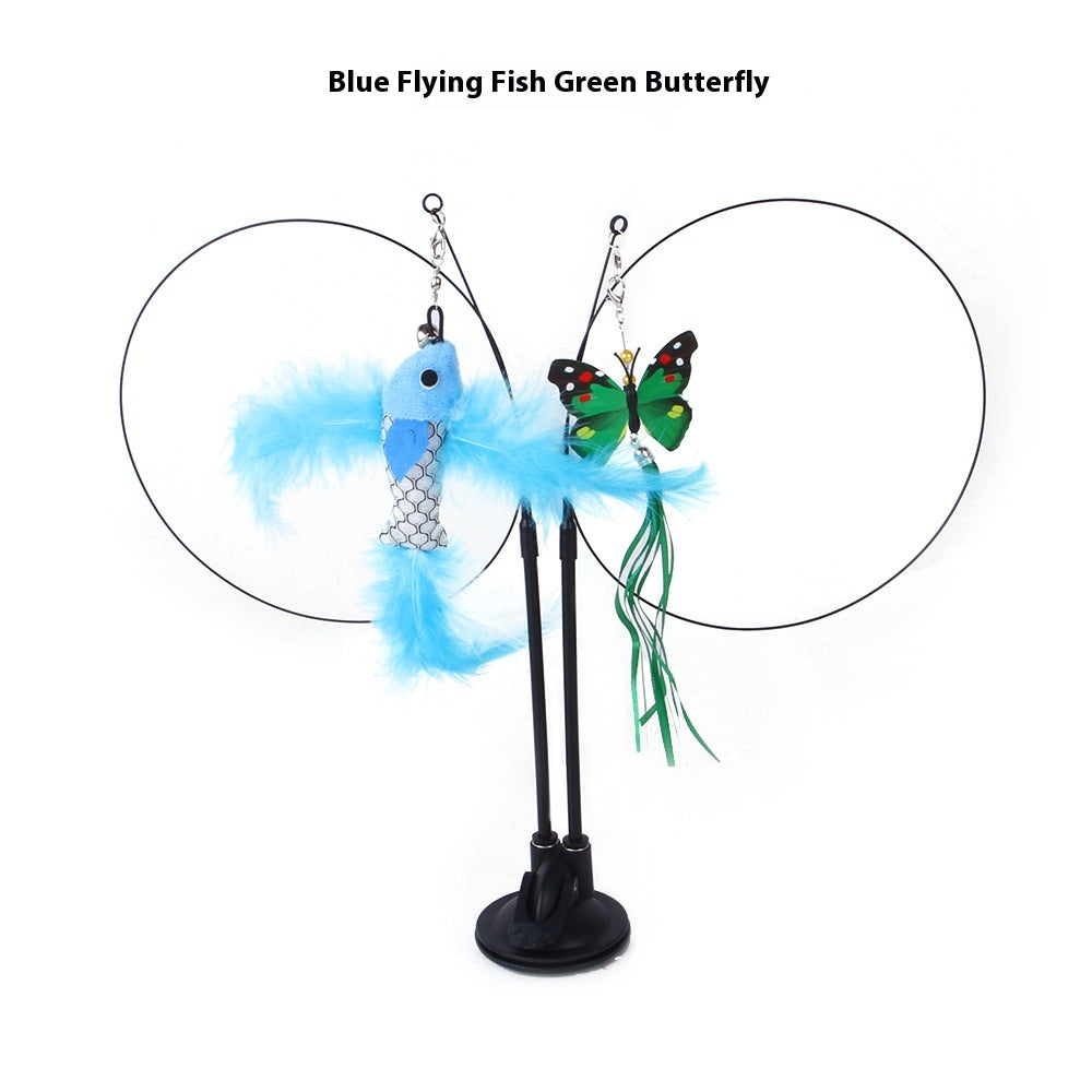 Blue feathered fish and green butterfly toys attached to thin black wire loops on a black suction cup base.