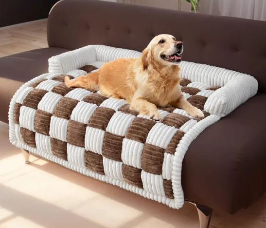 A golden retriever relaxes on the ultra-soft Creative critters CozyPlush Pet Bed, featuring a brown and white checkered design on a sofa.