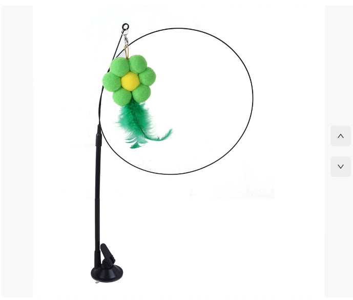 Green and yellow plush flower cat teaser toy with feathers on a flexible black wire wand and suction cup base.